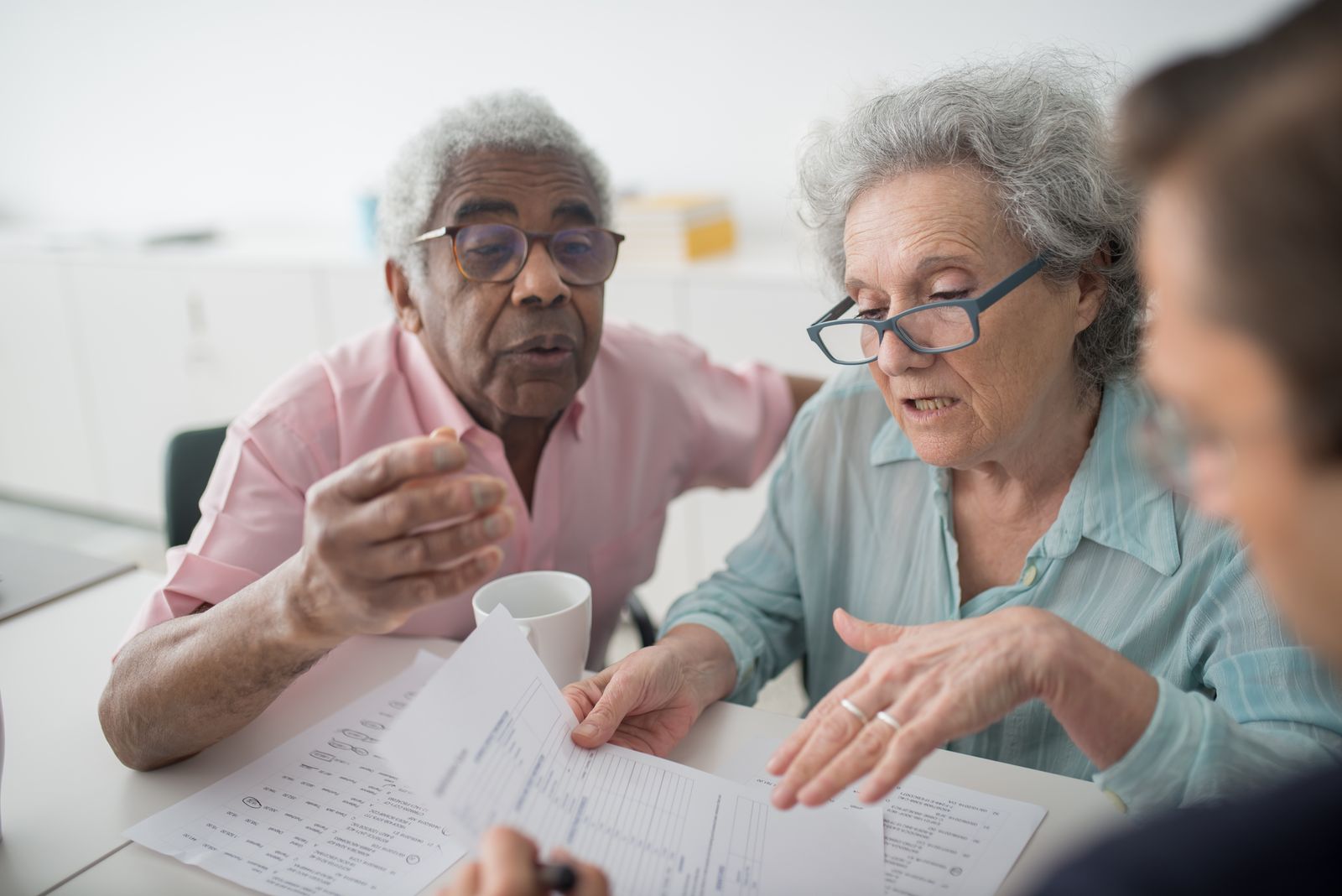 Advisor reviewing documents at a table with clients